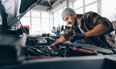 Mechanic examining car in auto car repair service center